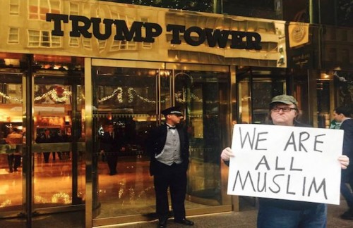 Michael Moore holding "We Are All Muslim" Signs